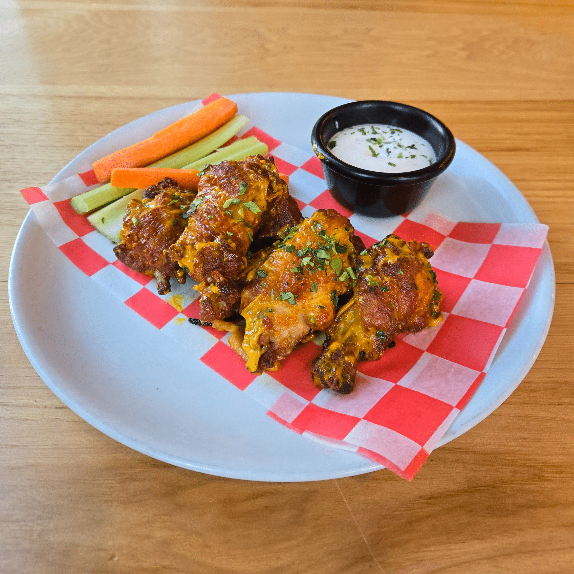 Image depicts 10 mango habanero wings, served with celery, carrots and your choice of ranch or bleu cheese dipping sauce.